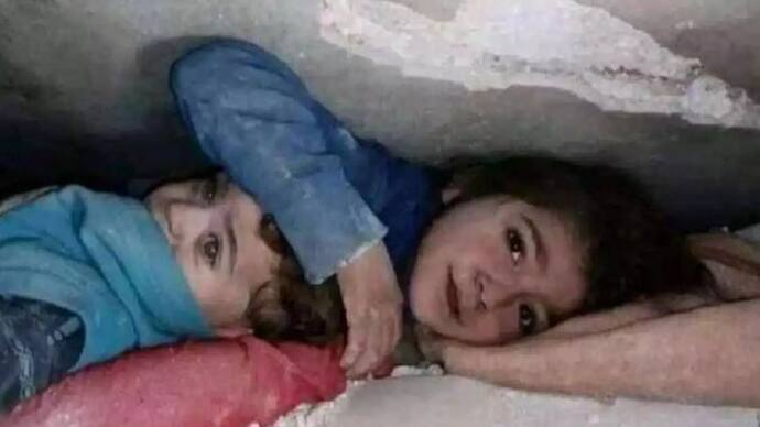 Syrian girl protecting brother 