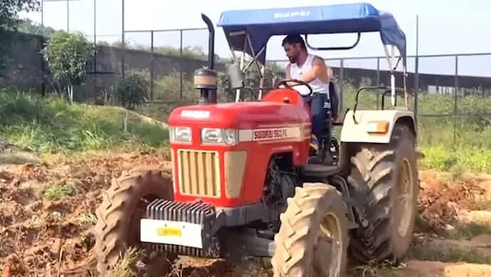 Mahendra Singh Dhoni plowing the field with a tractor