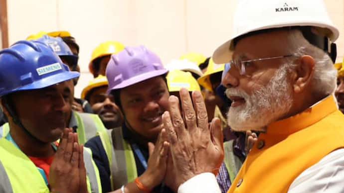 PM Modi interact with workers of new parliament building
