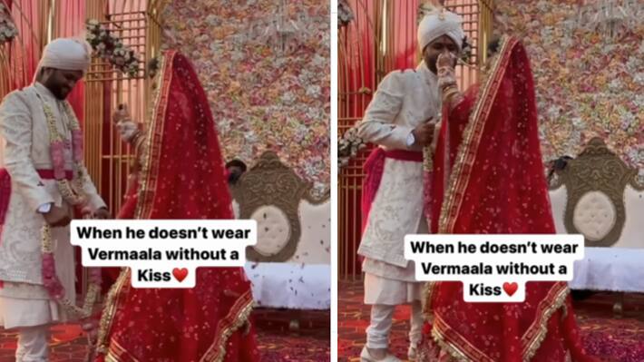 groom asking for a kiss during varmala