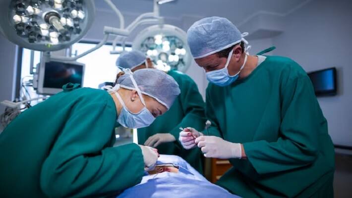 surgeons performing operation in operation theater