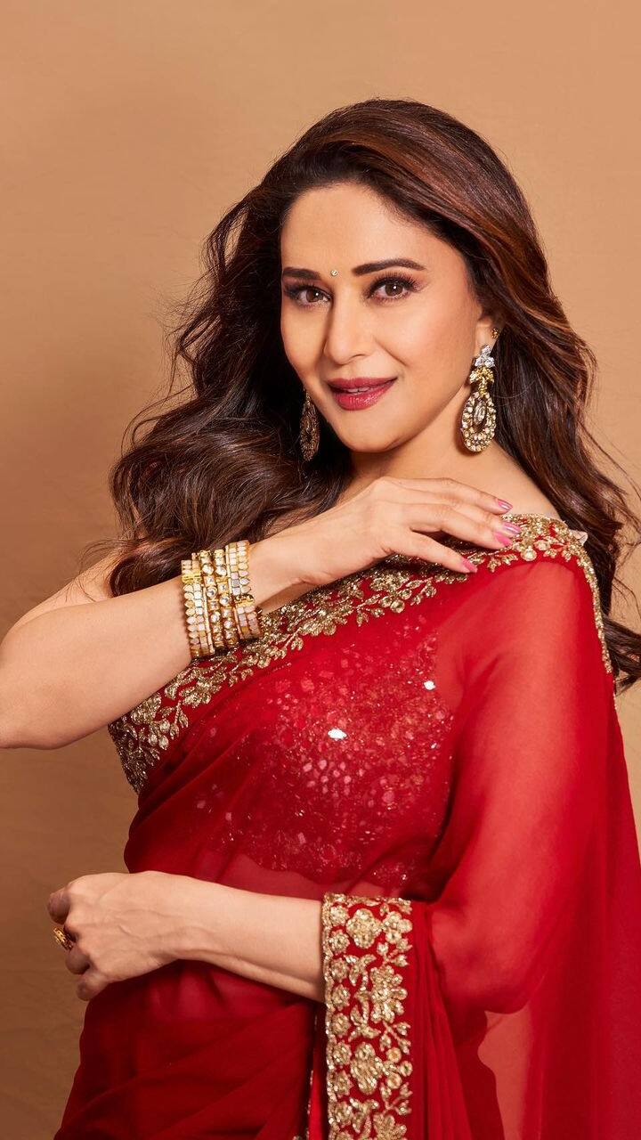 At the Zee Guarav Awards 2018, actress Madhuri Dixit rocked a blue Paithani  silk saree by Madhurya Creations. Statement gold jewelry set by Jaipur Gems  accentua…